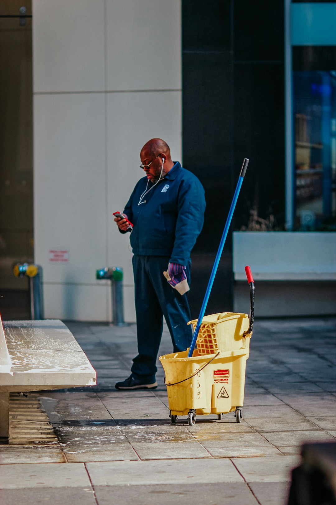 man-in-blue-suit-holding-yellow-plastic-basket-jgaxgjxklpw